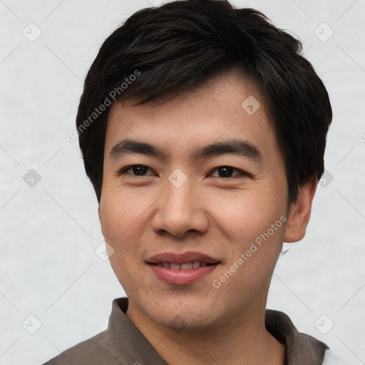 Joyful asian young-adult male with short  black hair and brown eyes