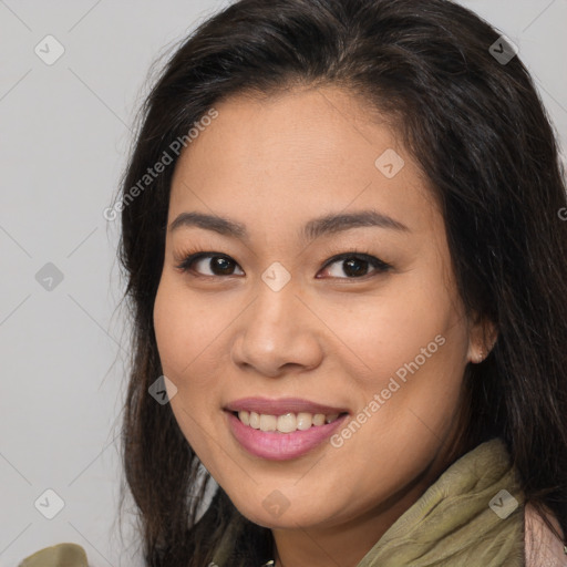 Joyful asian young-adult female with long  brown hair and brown eyes