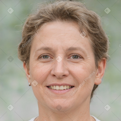 Joyful white adult female with short  brown hair and grey eyes