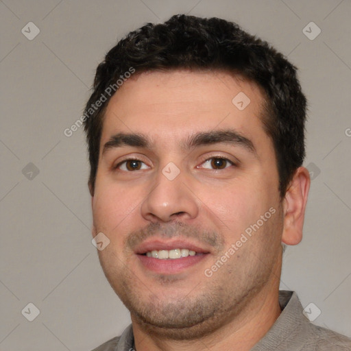 Joyful white young-adult male with short  black hair and brown eyes