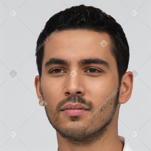 Neutral latino young-adult male with short  black hair and brown eyes