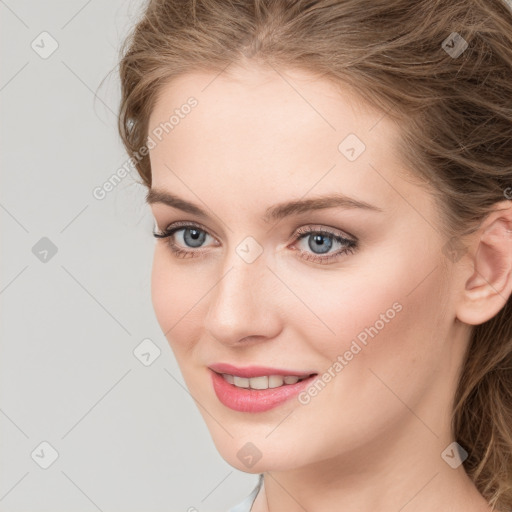 Joyful white young-adult female with long  brown hair and blue eyes