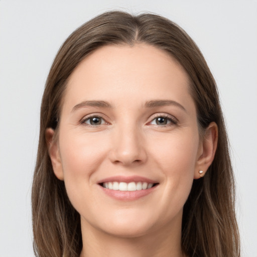 Joyful white young-adult female with long  brown hair and grey eyes