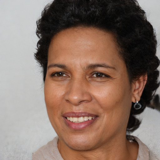 Joyful latino adult female with short  brown hair and brown eyes