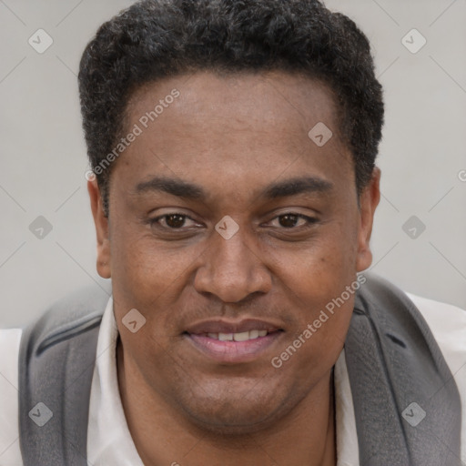 Joyful black adult male with short  brown hair and brown eyes