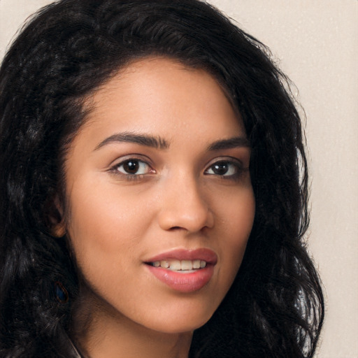 Joyful latino young-adult female with long  brown hair and brown eyes