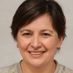 Joyful white adult female with medium  brown hair and brown eyes