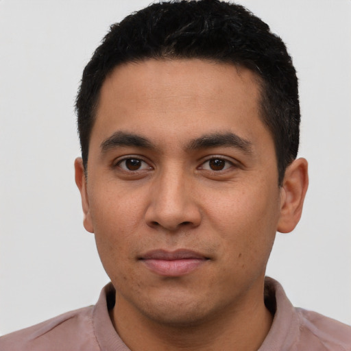 Joyful latino young-adult male with short  black hair and brown eyes