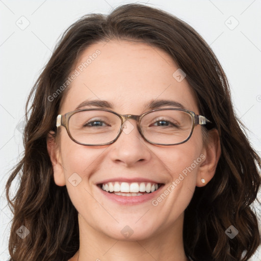 Joyful white adult female with long  brown hair and blue eyes