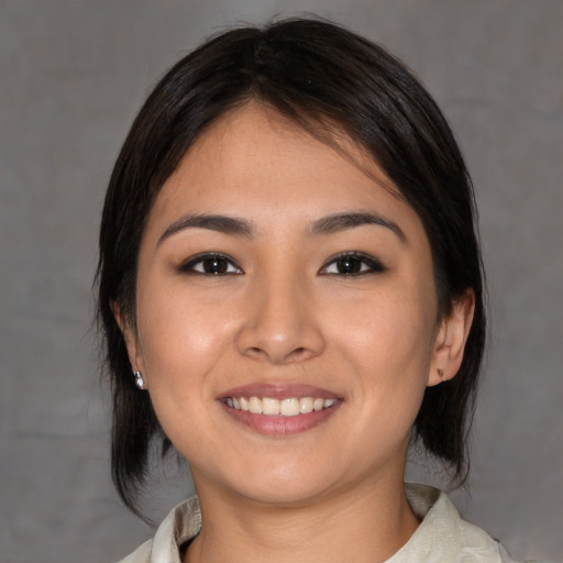 Joyful asian young-adult female with medium  brown hair and brown eyes