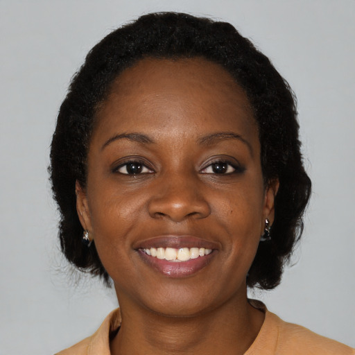 Joyful black young-adult female with medium  black hair and brown eyes