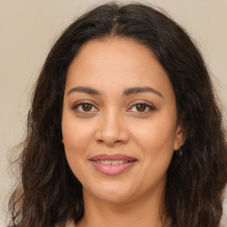 Joyful latino young-adult female with long  brown hair and brown eyes