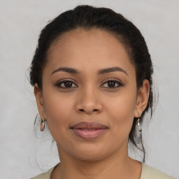 Joyful latino young-adult female with medium  brown hair and brown eyes