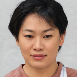 Joyful asian young-adult female with short  brown hair and brown eyes