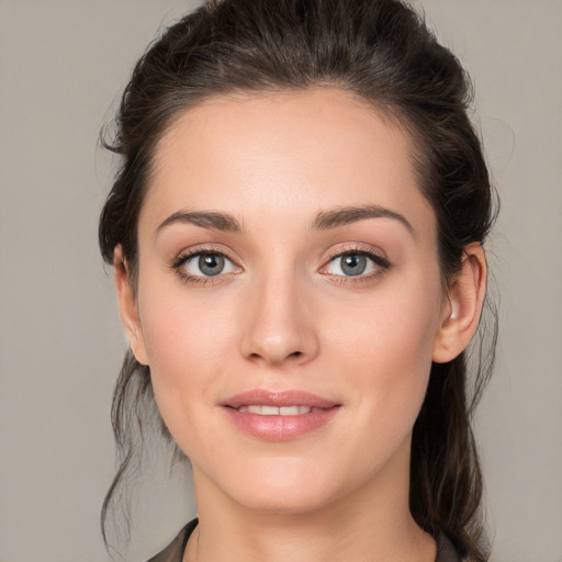 Joyful white young-adult female with medium  brown hair and grey eyes