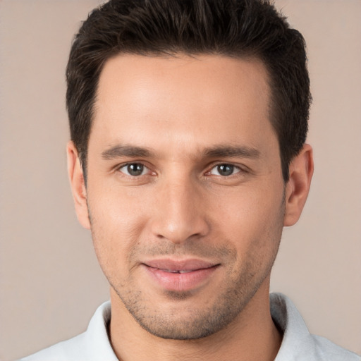 Joyful white young-adult male with short  brown hair and brown eyes