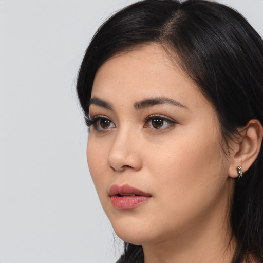 Neutral latino young-adult female with long  black hair and brown eyes