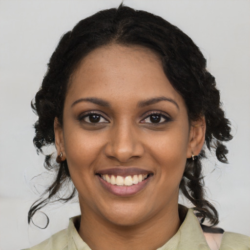 Joyful black young-adult female with medium  brown hair and brown eyes