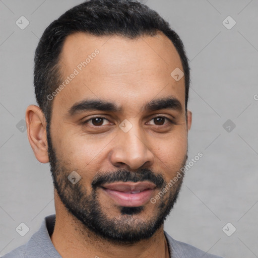 Joyful latino young-adult male with short  black hair and brown eyes