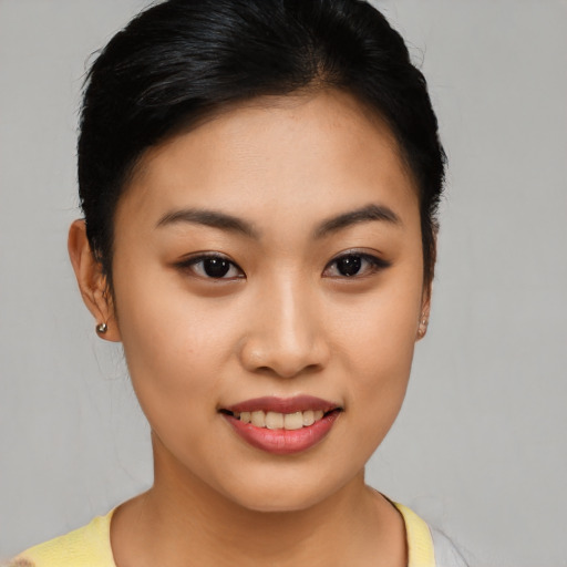 Joyful asian young-adult female with short  brown hair and brown eyes