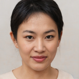 Joyful asian young-adult female with short  brown hair and brown eyes