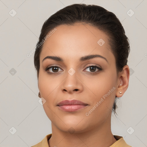 Joyful latino young-adult female with short  brown hair and brown eyes