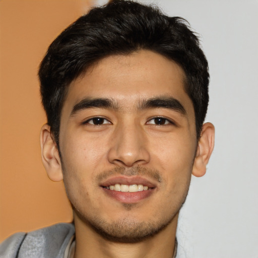 Joyful asian young-adult male with short  brown hair and brown eyes