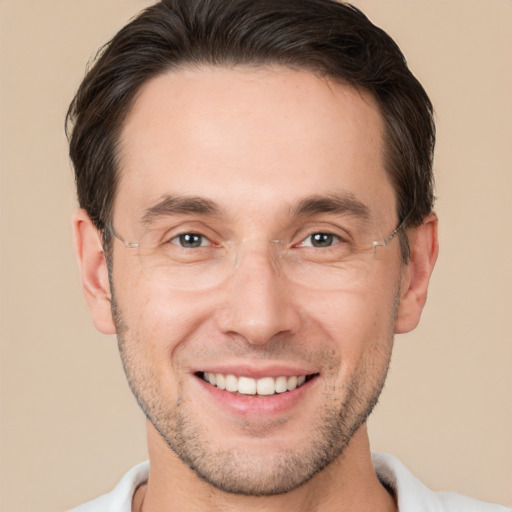 Joyful white adult male with short  brown hair and brown eyes