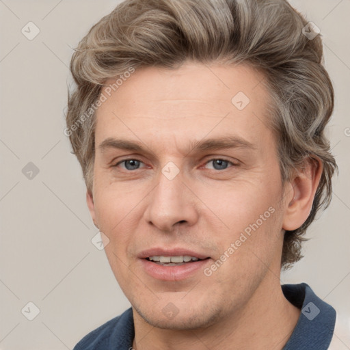 Joyful white adult male with short  brown hair and grey eyes