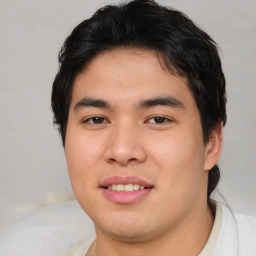 Joyful asian young-adult male with short  brown hair and brown eyes