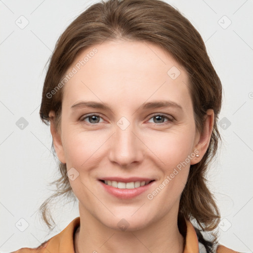 Joyful white young-adult female with medium  brown hair and grey eyes