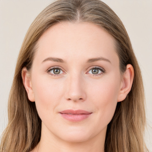 Joyful white young-adult female with long  brown hair and blue eyes