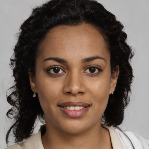 Joyful black young-adult female with medium  brown hair and brown eyes