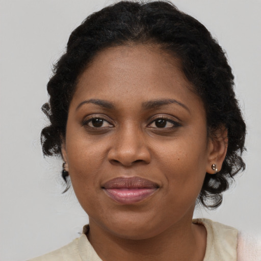 Joyful black adult female with short  brown hair and brown eyes