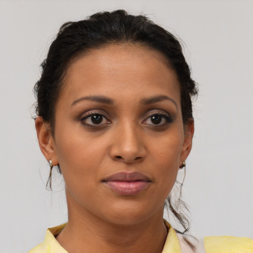 Joyful latino young-adult female with short  brown hair and brown eyes