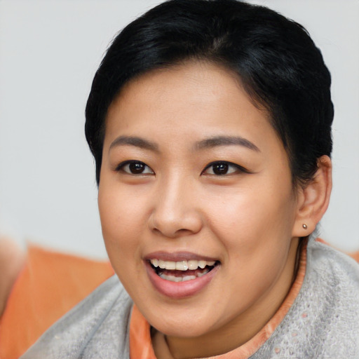 Joyful asian young-adult female with short  black hair and brown eyes