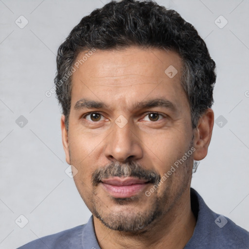 Joyful white adult male with short  black hair and brown eyes