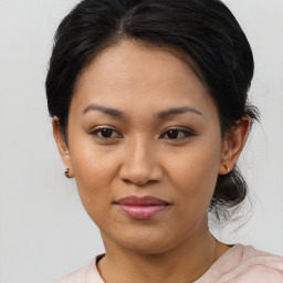 Joyful asian young-adult female with medium  brown hair and brown eyes