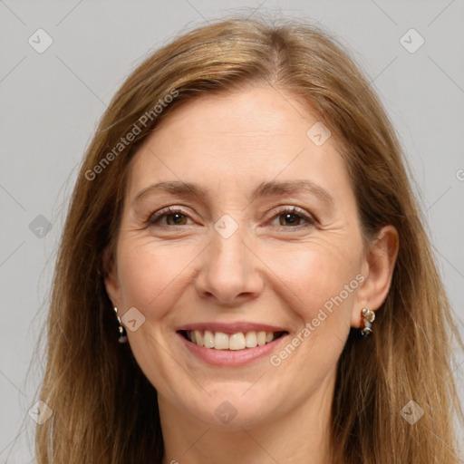 Joyful white adult female with long  brown hair and brown eyes