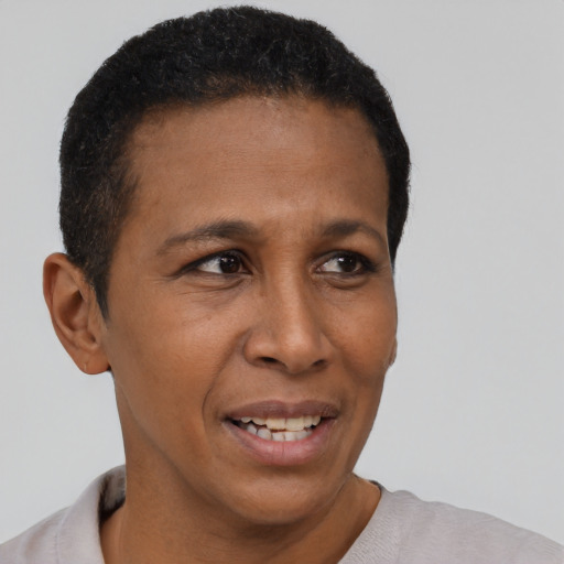 Joyful black adult female with short  black hair and brown eyes