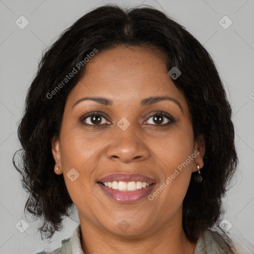 Joyful black adult female with medium  brown hair and brown eyes