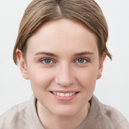 Joyful white young-adult female with short  brown hair and grey eyes