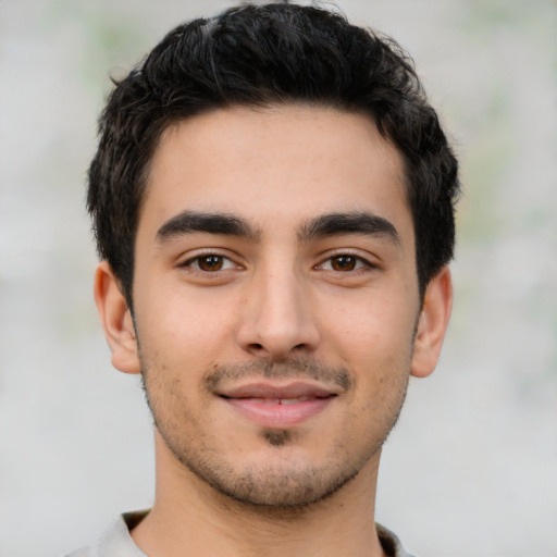 Joyful latino young-adult male with short  black hair and brown eyes