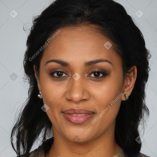 Joyful black adult female with long  brown hair and brown eyes