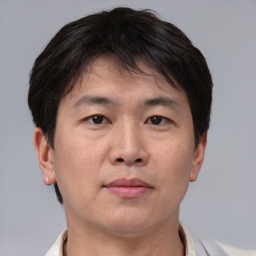 Neutral asian adult male with short  brown hair and brown eyes