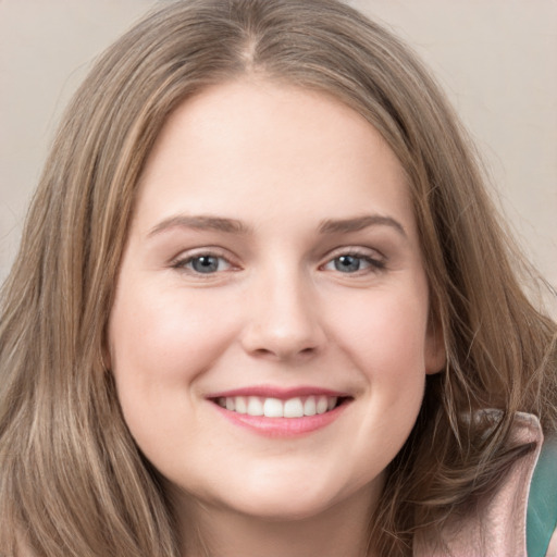 Joyful white young-adult female with long  brown hair and grey eyes