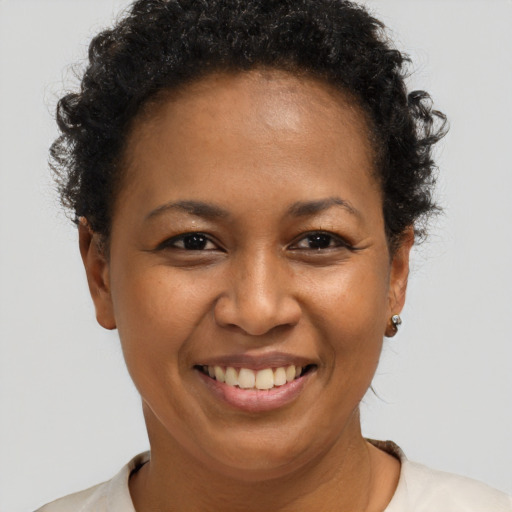Joyful black adult female with short  brown hair and brown eyes