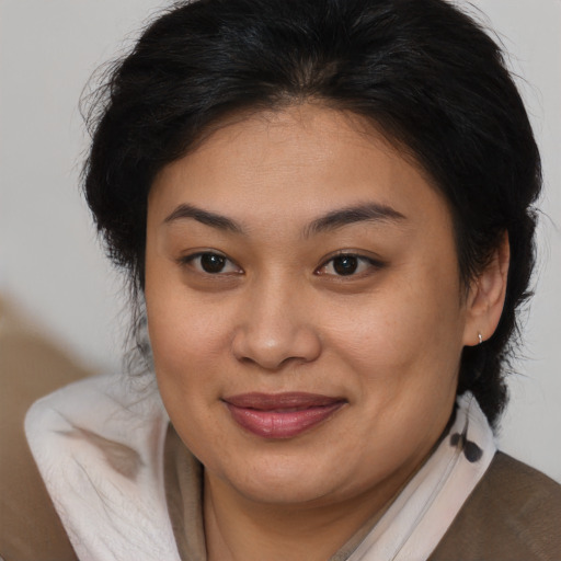 Joyful asian young-adult female with medium  brown hair and brown eyes