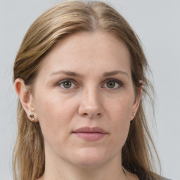 Joyful white adult female with long  brown hair and grey eyes