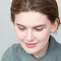 Joyful white young-adult female with medium  brown hair and blue eyes